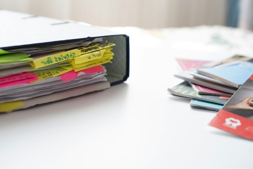 School box-files with organized reading document notes on table. Office supplies